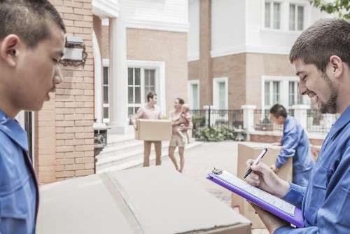 Furniture collection team handling a sofa pickup in a London home