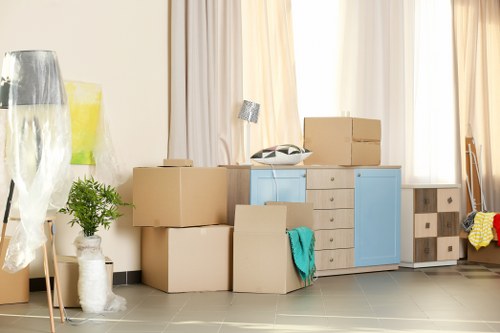 Removal team handling a London home move with boxes and furniture