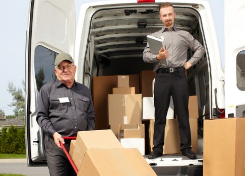 Movers loading items into a van for a London house move