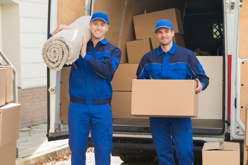 Removal team supporting a London home move with boxes and furniture