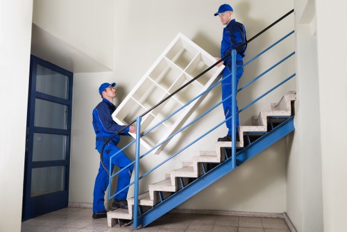 Mover navigating stairs and access challenges in a London property