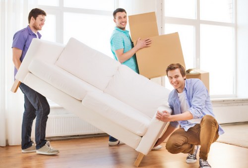 Local moving van navigating London streets with furniture
