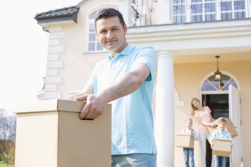 Removal company preparing items for transport in a London property