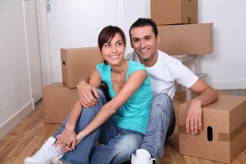 Professional movers carrying household furniture through a doorway