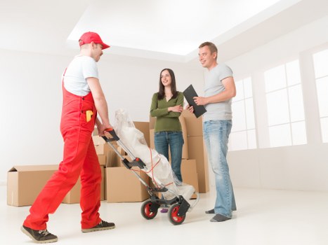 Removal team preparing a safe move with protective equipment and packing materials