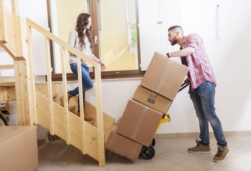 Boxes and furniture being loaded into a removal van in London
