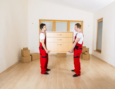 Office movers handling desks and IT equipment carefully